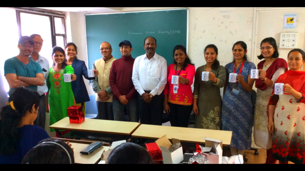 Students holding Cup with Good 4 Nothing Name in one of the classroom