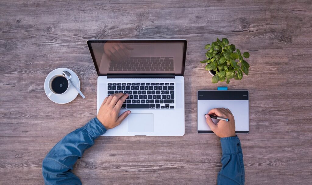 Person with laptop making notes